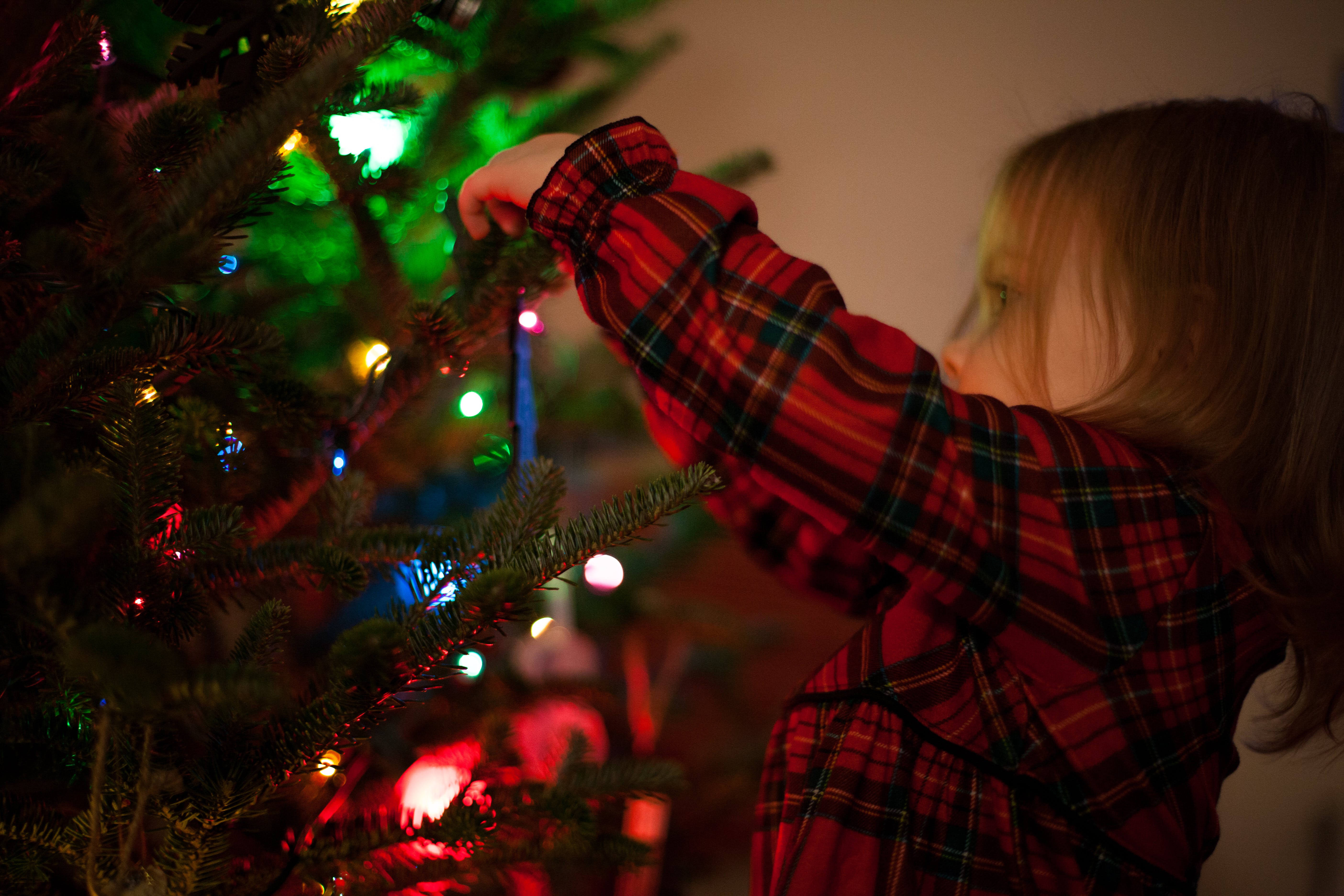 Child hanging tree decorations